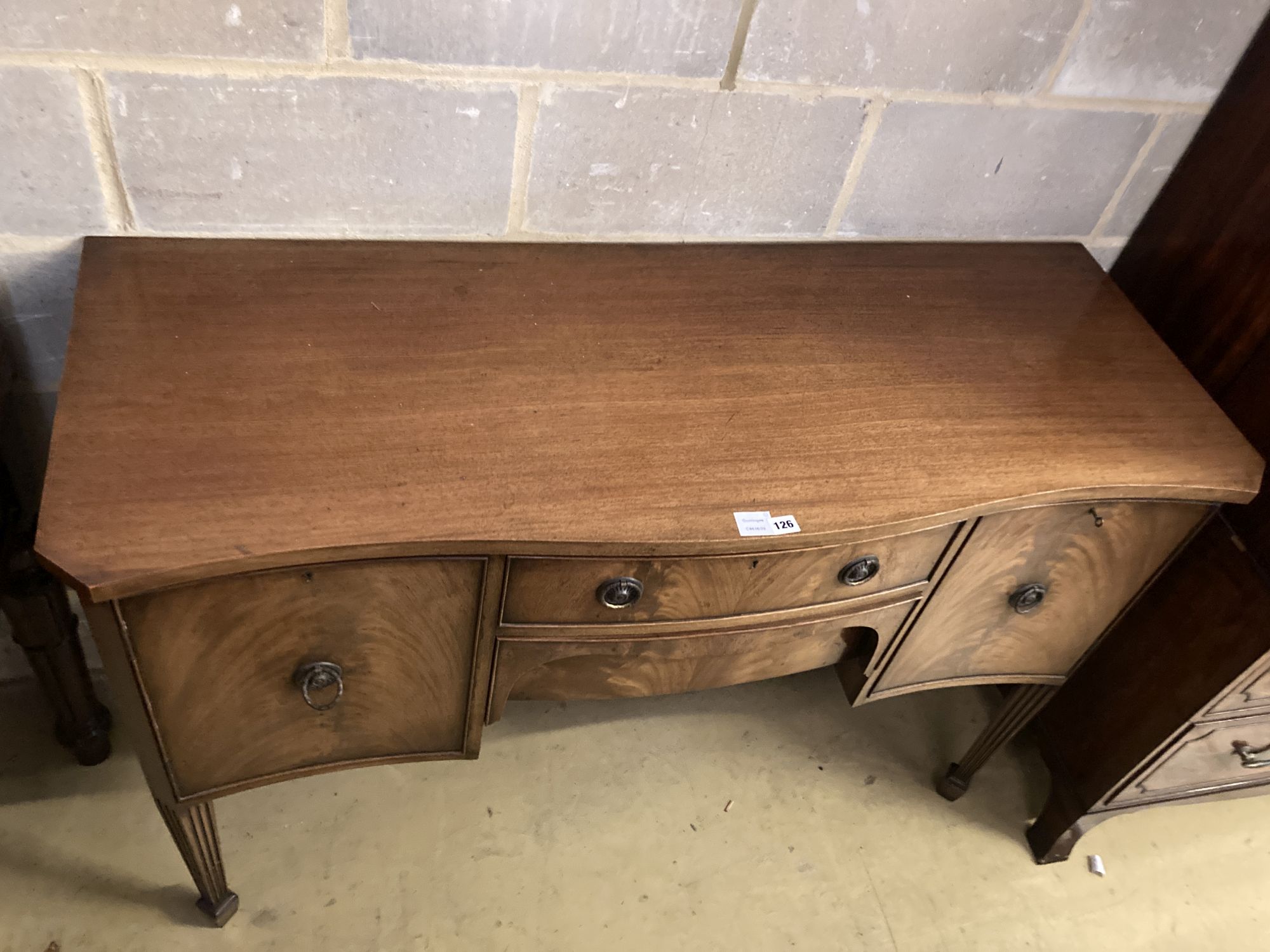 A George III style mahogany serpentine fronted sideboard, length 138cm, depth 52cm, height 92cm